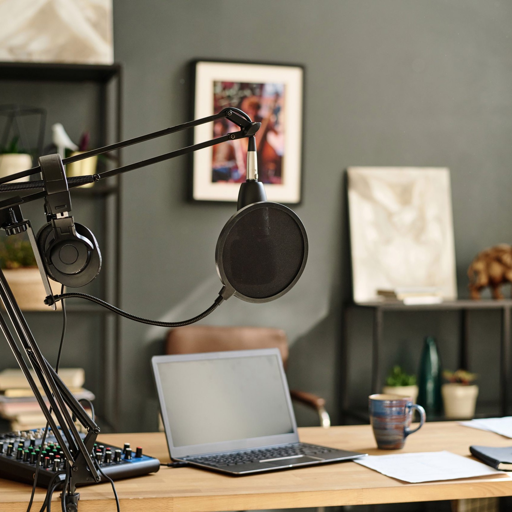 Laptop surrounded by sound recording equipment standing on workplace of modern blogger, radio presenter or deejay in studio